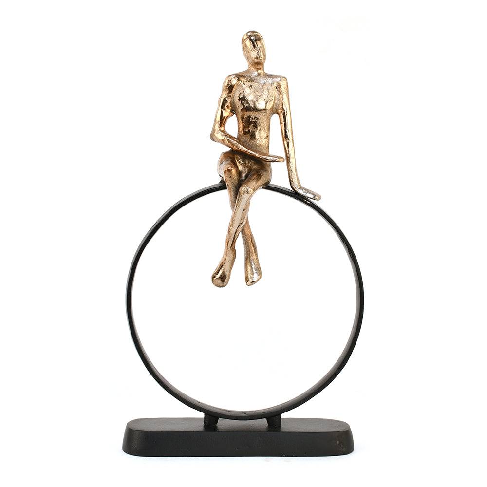 Man Sitting On Cirque Decorative Metal Showpiece- Black & Gold