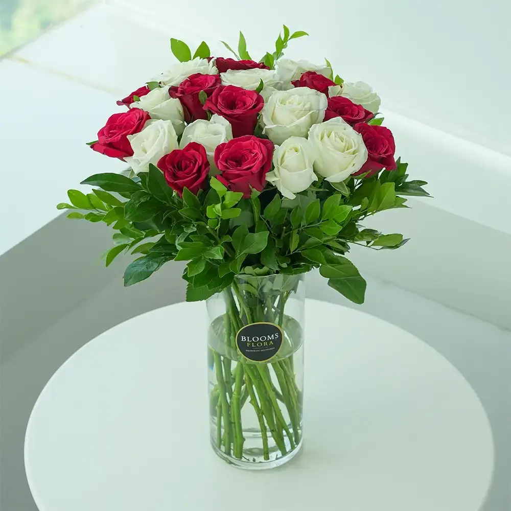 White and Red Roses In Glass Vase