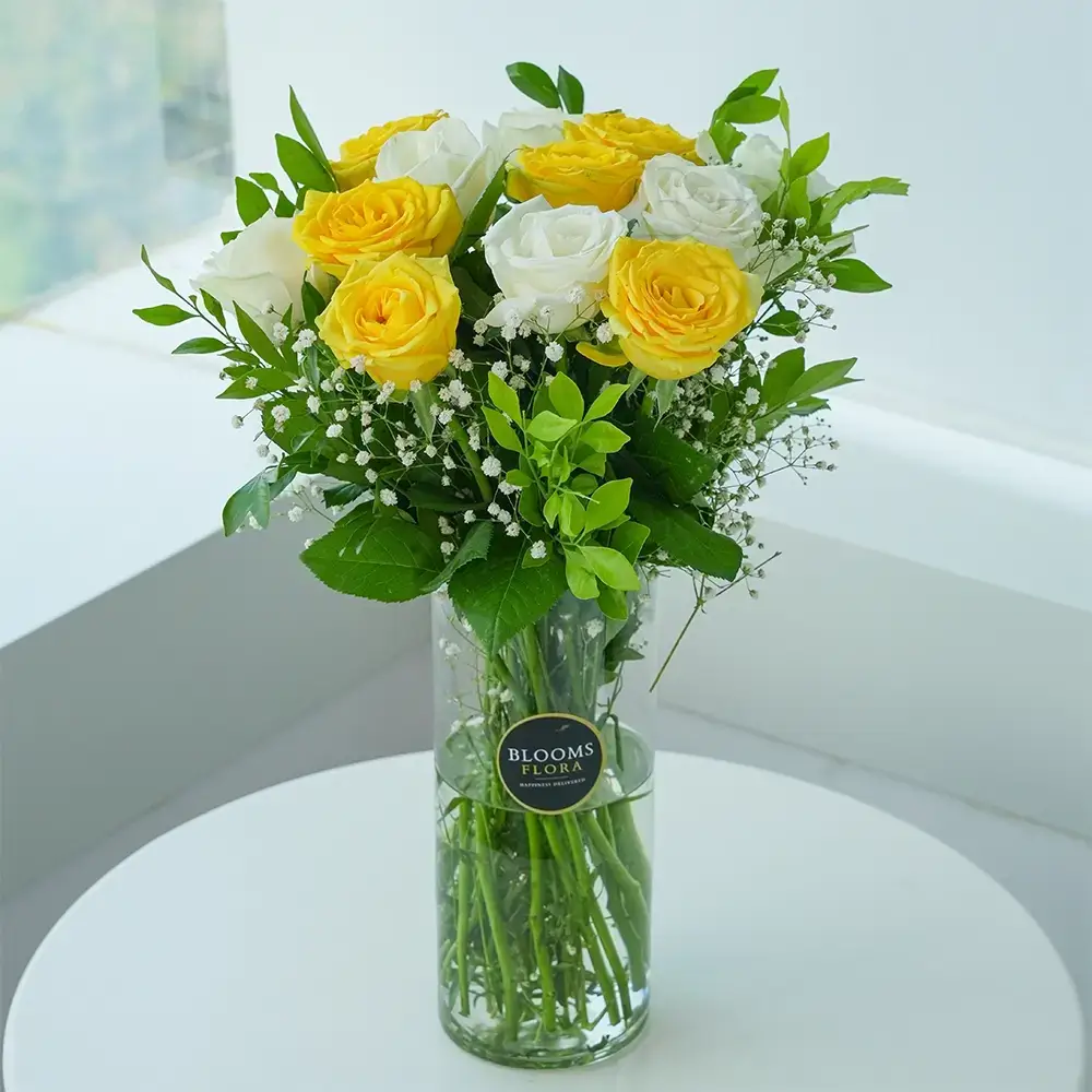 White and Yellow Roses In Glass Vase