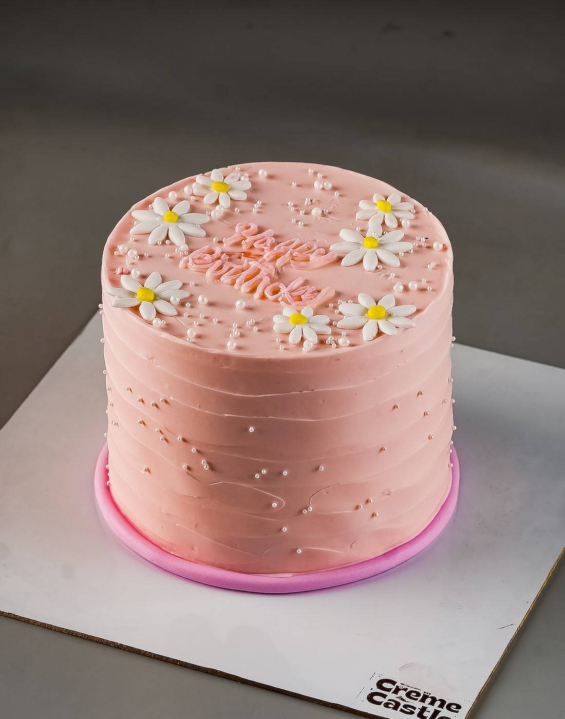 Pink cake with white flowers