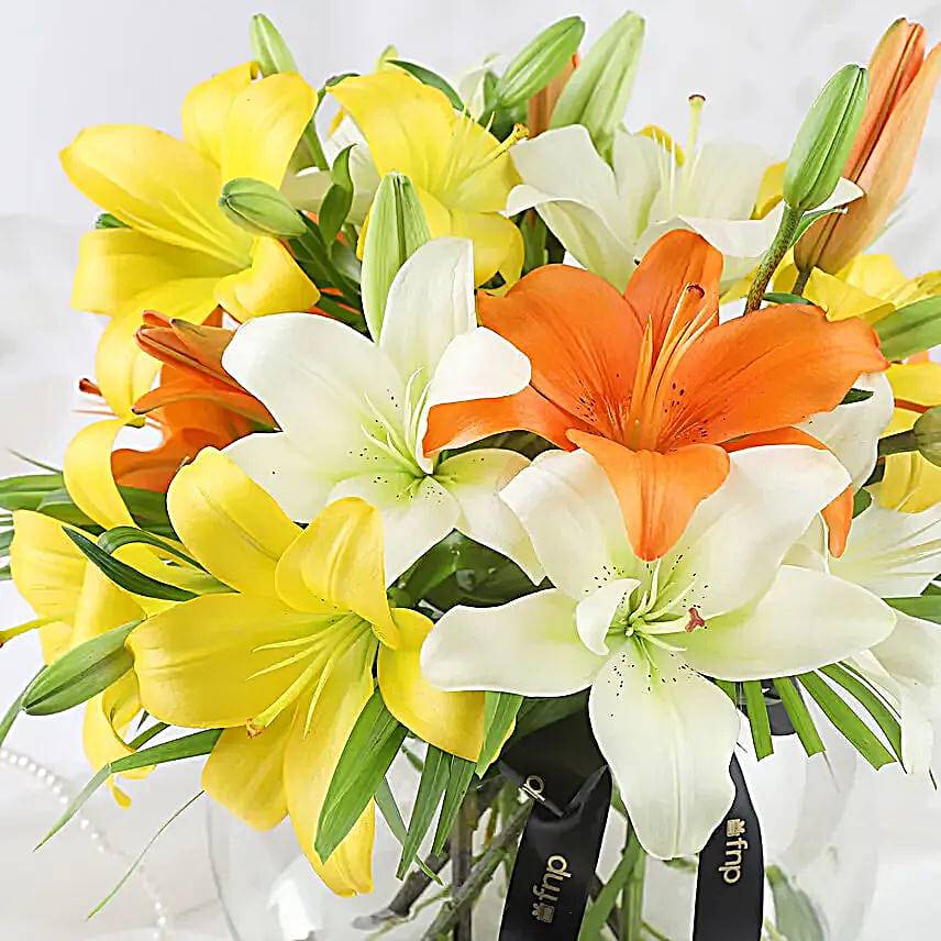 Mix Of Lilies In Fishbowl Vase